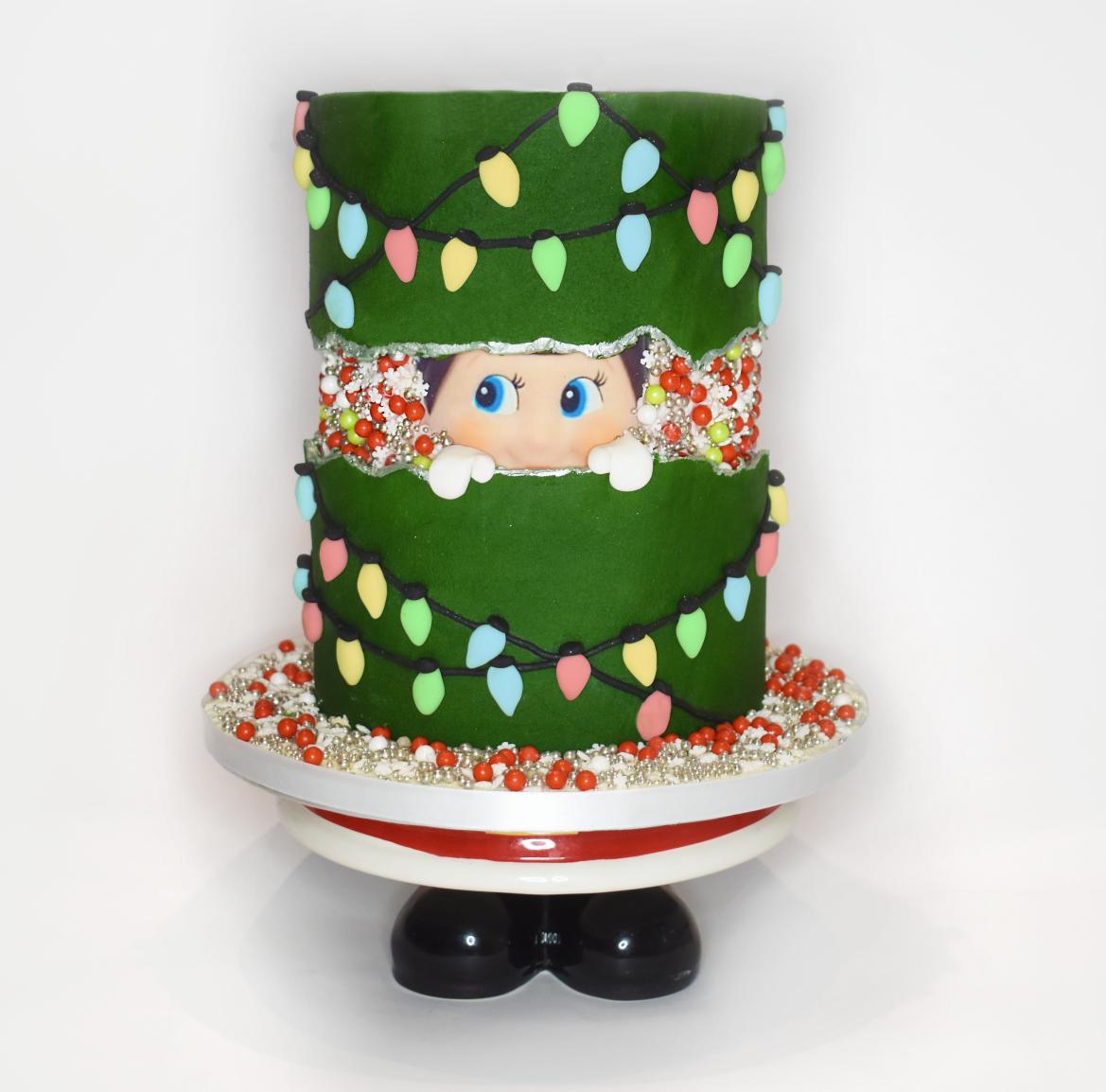 Elf on the shelf fault line cake using an A4 icing cake topper