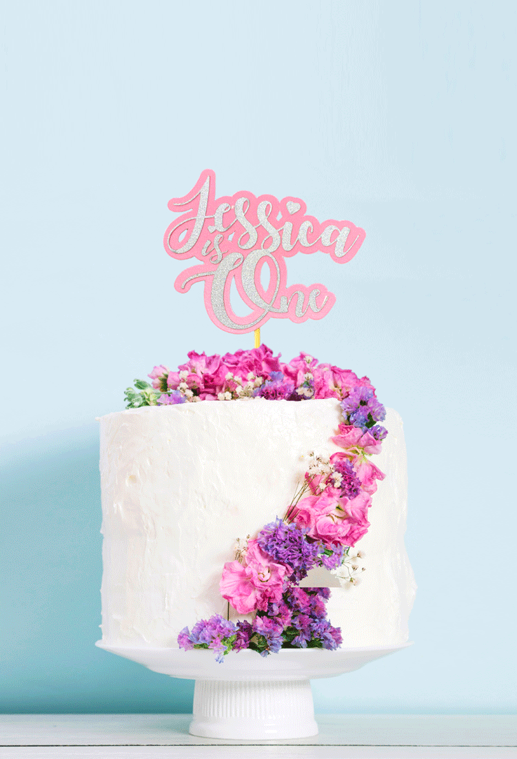 Jessica is One non edible cake topper in pink and silver glitter on a birthday cake
