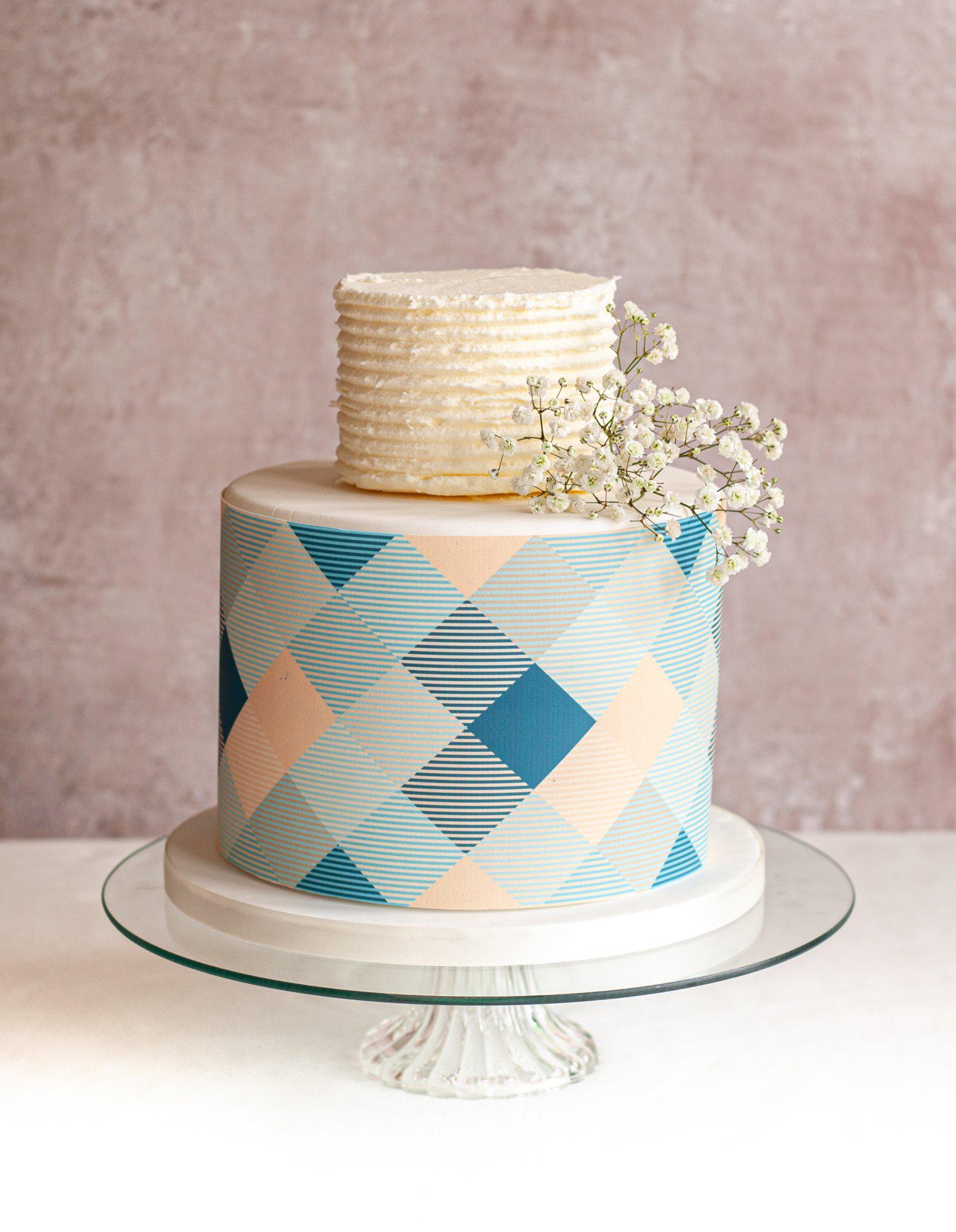 2 tier cake decorated with a blue and pale pink check cake wrap